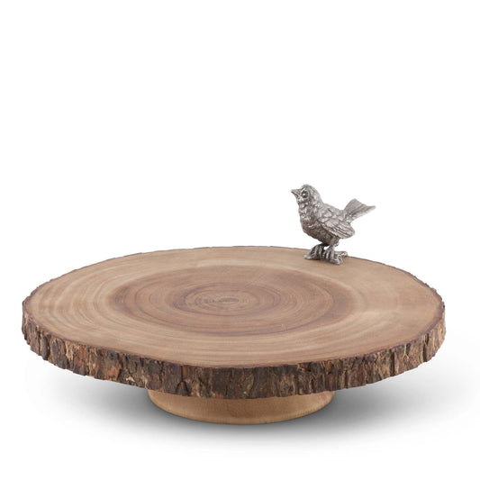 Tabla para quesos en laja de madera y un pájaro decorativo en peltre